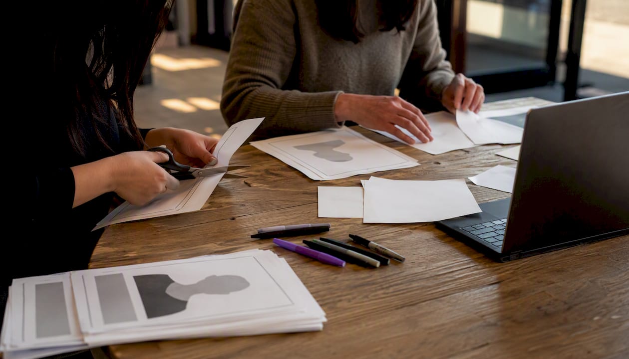 Hands making cold-case flyers