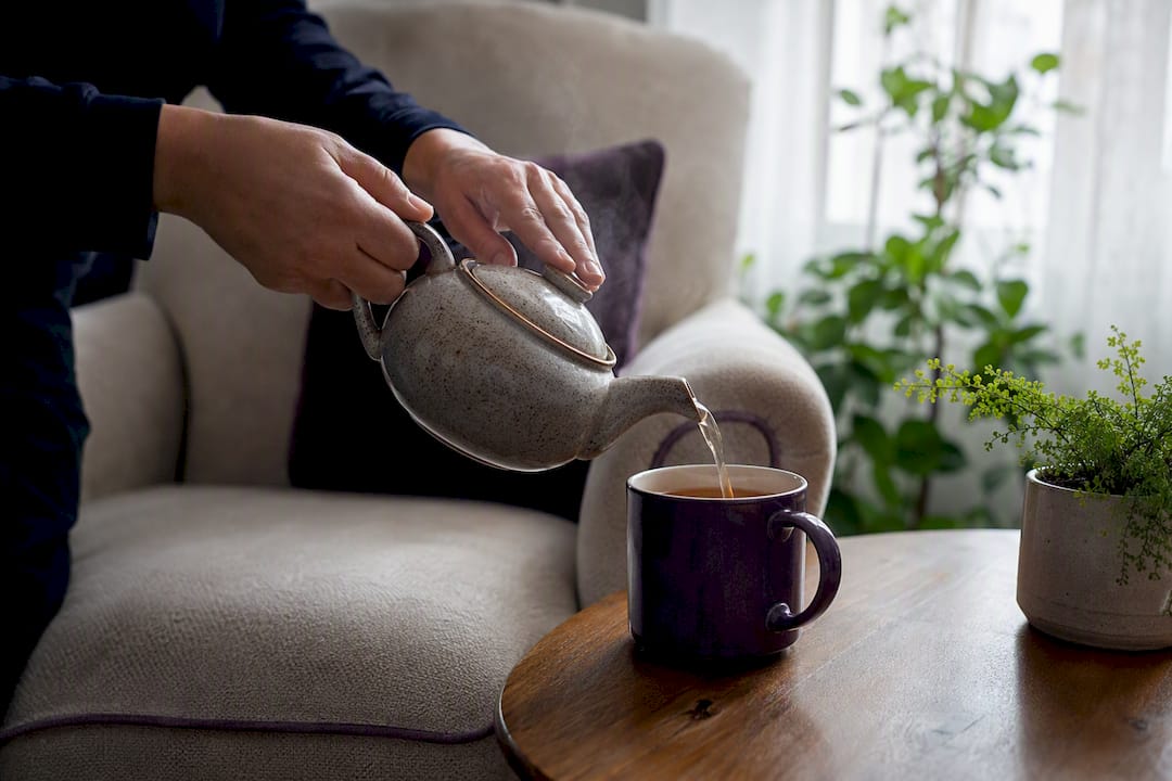 Hands pouring tea in counseling office
