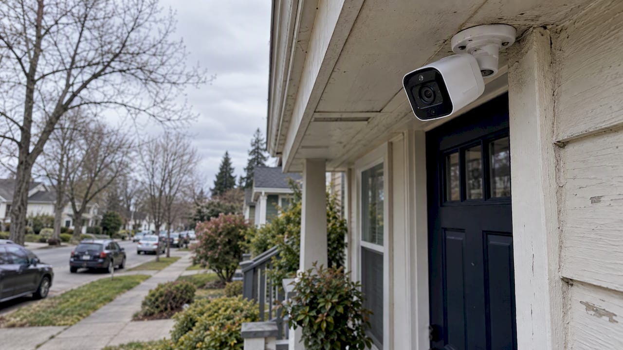 Security camera overlooking a residential sidewalk