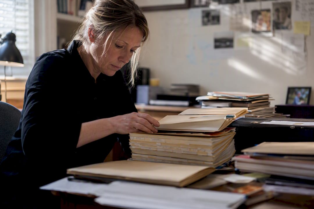 Investigator opening archival case file drawer