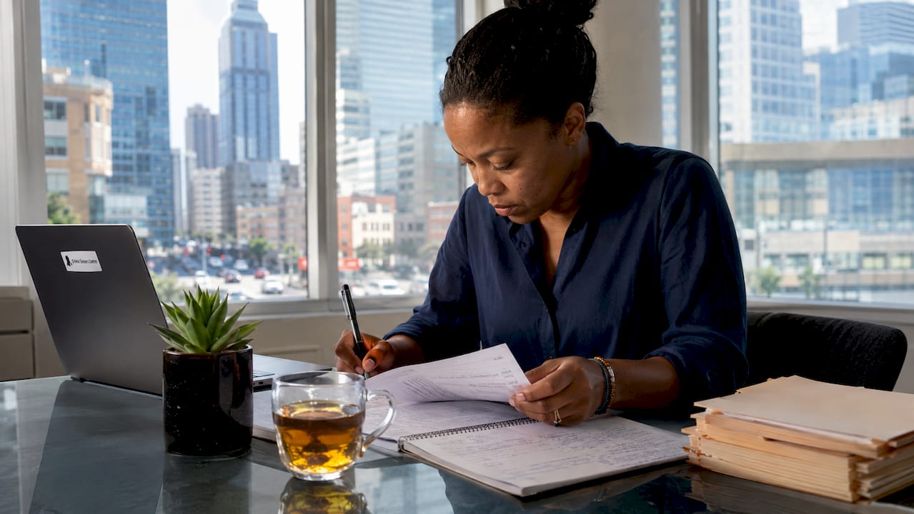 Woman researching true crime stories at home